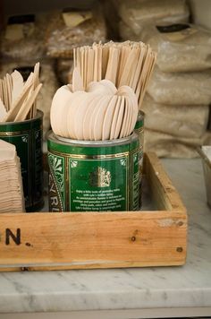 there are two jars with toothbrushes in them on the counter next to other items