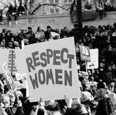 a group of people holding signs that read respect women