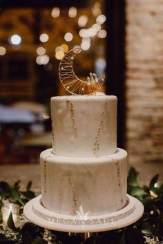 a three tiered white cake sitting on top of a table