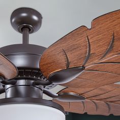 a ceiling fan with two wooden blades attached to it's center blade and light fixture