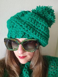 What a great look for Christmas This will also keep you warm at the St. Patrick's Day parade, and in style too.  This green slouch hat stenches enough to fit a man or a women.  It is made with two strands of emerald green worsted weight yarn for extra warmth. The ribbed band keeps the hat in place, while the rest of the hat provides enough space to accommodate a larger head. Finished with a large green pom pom and a comfortable slouch style you can't go wrong! This goes great with it's matching Irish Hat, New Rochelle, Slouch Hat, Slouchy Hat, Worsted Weight Yarn, Worsted Weight, Infinity Scarf, Emerald Green, Caps Hats