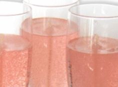 three glasses filled with pink liquid sitting next to each other