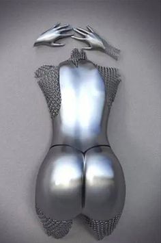 a silver bodysuit with metal mesh on the bottom and sides, in front of a white background