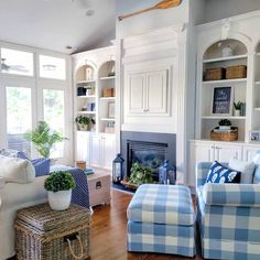 a living room filled with furniture and a fire place in the middle of a room