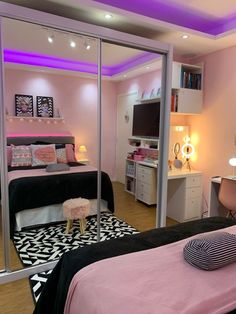 a bedroom with pink walls and black and white decor