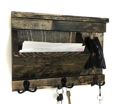 a coat rack with keys and mail hanging on it