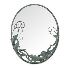 a mirror that is sitting on top of a wall next to a fish and seaweed