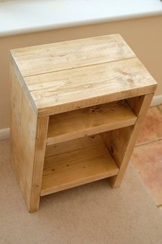 a small wooden shelf sitting on the floor