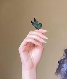 a woman holding a green leaf in her hand