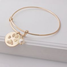 Double sided actual paw print personalized expandable bracelet Wear this bangle bracelet in honor of your beloved pet.A name can be engraved under each print at no additional cost.• All sterling silver or 14k gold filled ~ not plated• Pendant diameter: 3/4" (19mm)~ (size guide pictured in last image)• Gift boxed• expand the bracelet (up to approx. 3" ID) for easy-on & easy-off wearPAWS: I can work with a photo of the paw itself, an ink imprint or an image of a three-dimensional clay mold for paw Monogram Pendant Necklace, Nameplate Bracelet, Paw Print Pendant, Initial Earrings Studs, Cat Prints, Engraved Cuff, Expandable Bangle Bracelet, Pet Memorial Jewelry, Silver Monogram