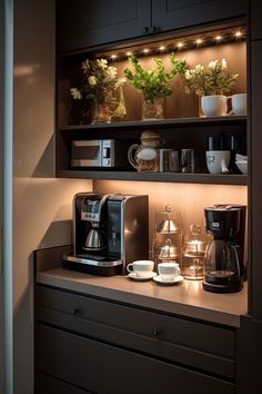 a coffee maker and some cups on a counter