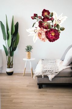 a living room filled with furniture and flowers on the wall