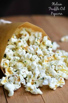 a bag filled with popcorn sitting on top of a wooden table