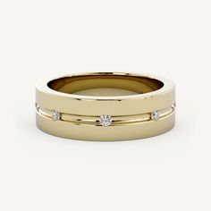 a yellow gold wedding ring with three diamonds on the side and two rows of sides