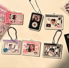 four keychains with pictures of people in the shape of hearts and heart - shaped frames