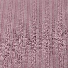 a close up view of a pink knitted material with small ridges and lines on it