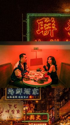 two people sitting at a table in front of neon signs