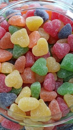 a bowl filled with gummy bears sitting on top of a table