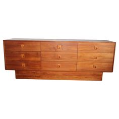 a large wooden dresser sitting on top of a white wall