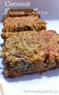 two pieces of granola bars sitting on top of a white plate with the words coconut cream bars