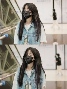 a woman wearing a face mask while standing next to an escalator