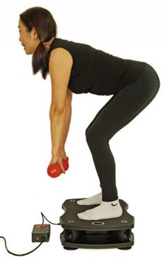 a woman standing on top of a weight scale holding a red object in her right hand