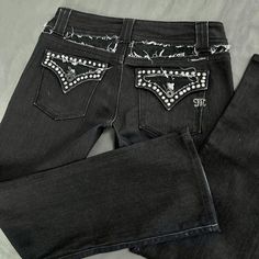 measurements: - size 30 - 16.5 inch waist - 38 inch length - 29 inch inseam - 8 inch rise Eyelet Jeans, Edgy Fitted Flare Jeans With Five Pockets, Punk Style Fitted Mid-rise Jeans, Fitted Black Pants With Rivets, Y2k Washed Black Bottoms With Pockets, Fitted Black Distressed Flare Jeans, Gothic Black Straight Leg Jeans, Black Gothic Straight Leg Jeans, Bejeweled Jeans Y2k