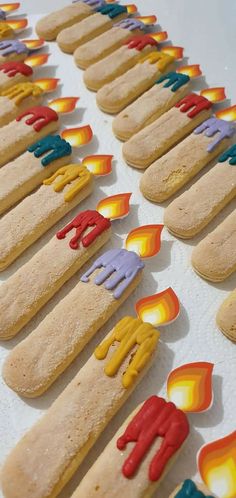 there are many cookies that have been decorated with candles in the shape of hands and feet