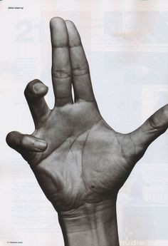 a black and white photo of a person's hand making the number two sign