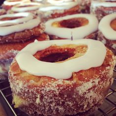 doughnuts with white icing sitting on a cooling rack