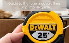 a hand holding a tape measure in front of a box with the words dewt on it