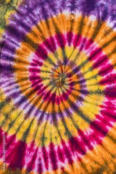 a colorful tie - dyed t - shirt is shown in the middle of an image