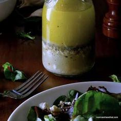 a salad with dressing in a jar on the table