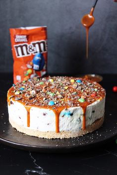 a cake covered in candy and caramel drizzle