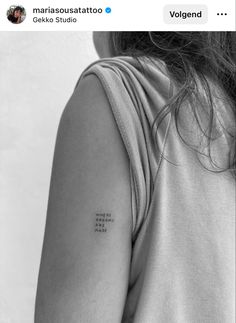 a woman with a small tattoo on her left arm and the words, love is in the air