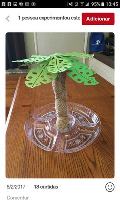 a tree made out of paper sitting on top of a wooden table