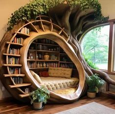 a room that has a tree like structure in the corner with bookshelves and couches