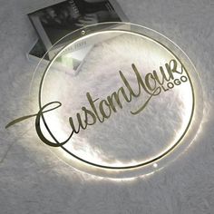 a glass plate with the word custoal yours on it next to a magazine