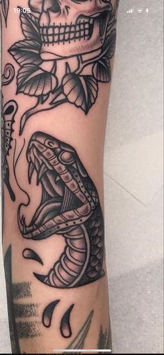 a person with a tattoo on their arm and a snake in the middle of it