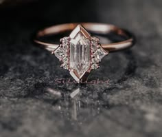 a close up of a diamond ring on a table