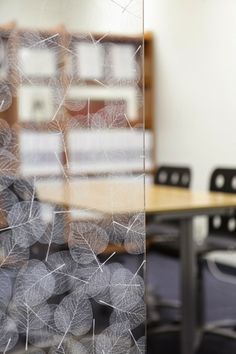 an office cubicle with chairs and a table in the foreground is blurry