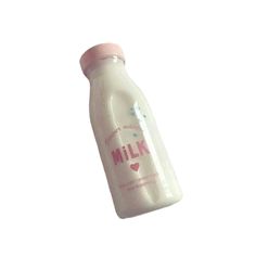 a bottle of milk is flying through the air with a pink cap on it's top