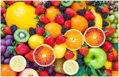 an assortment of fruits including oranges, kiwis and strawberries