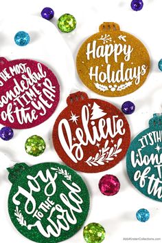 christmas ornament ornaments with happy holidays written on them and colorful glitters around them