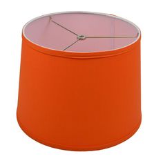 an orange lamp shade on a white background