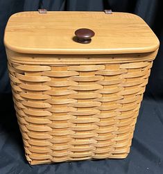 a wooden basket sitting on top of a black cloth