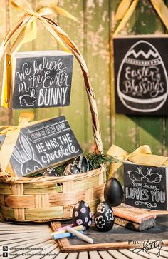 an easter basket with chalkboard signs on it and other items in front of the basket