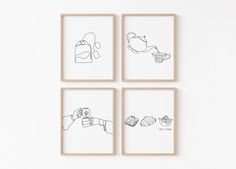 four framed drawings depicting different things on the wall, each with a hand holding a cupcake