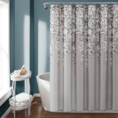 the shower curtain is decorated with silver flowers