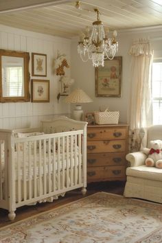 a baby's room with a crib, dresser and chair